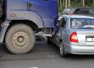 truck backing into a car